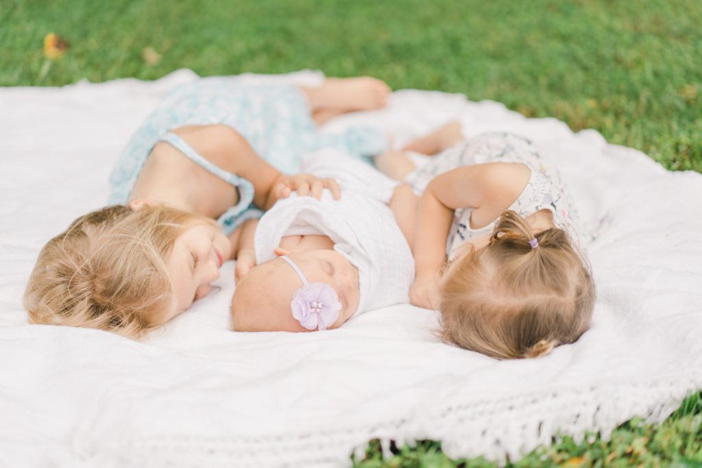 outdoor newborn photography with sisters in asheville nc