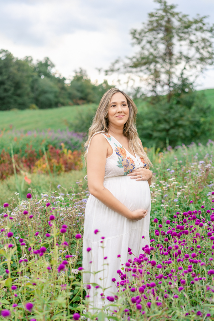 Mom with bump during maternity session in Asheville flower farm. Photo by Lauren Sosler Photography.