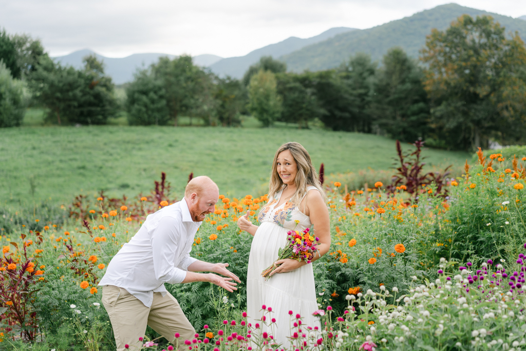 Silly photo with couple during maternity session at flower farm with mountains in the background. Photo by Black Mountain maternity photographer, Lauren Sosler Photography.