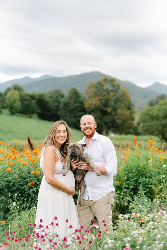 Couple with dog at their flower farm maternity session. Photo by Asheville maternity photographer, Lauren Sosler Photography.