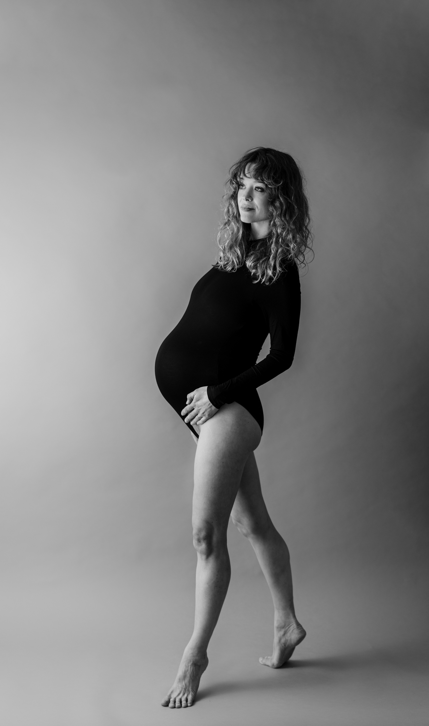 Black and white image of mom during dancer-inspired studio Maternity Session. Photo by Lauren Sosler Photography.