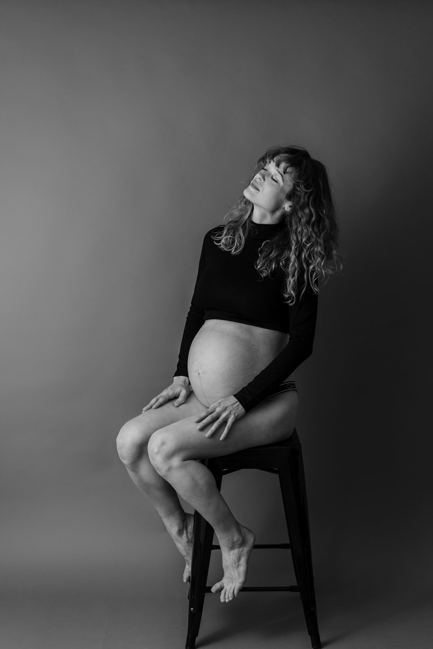 Black and white portrait of mom during dancer-inspired studio Maternity Session. Photo by Lauren Sosler Photography.