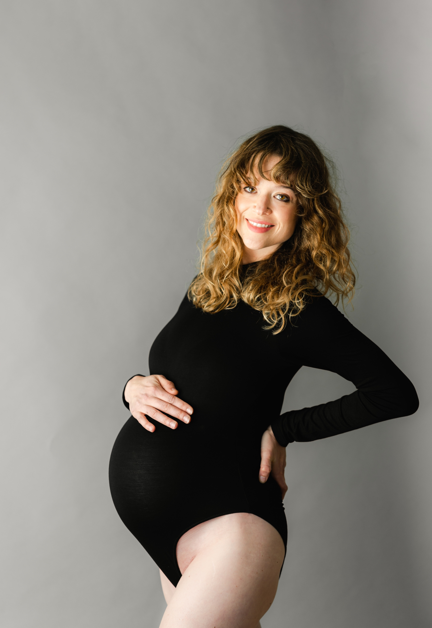 Mom wearing black leotard during maternity session inspired by dance. Photo bY Asheville Maternity Photographer, Lauren Sosler Photography.