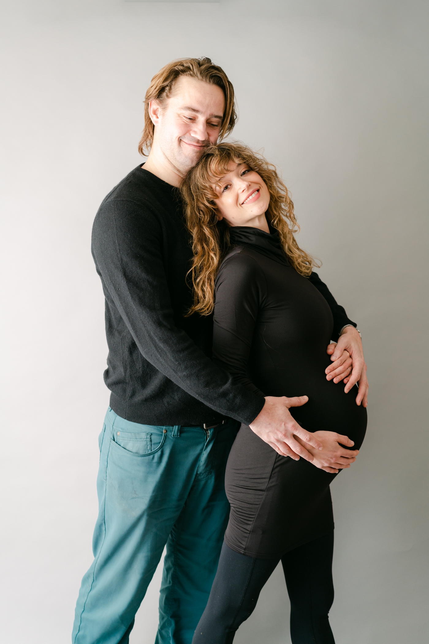 Mom and dad hugging during studio session. Photo by Asheville maternity photographer, Lauren Sosler Photography