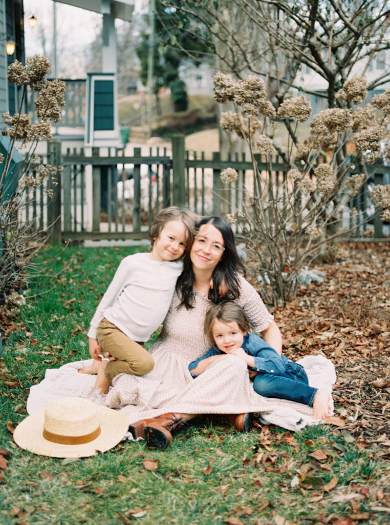 asheville-mom-with-sons-sitting-in-backyard-garden