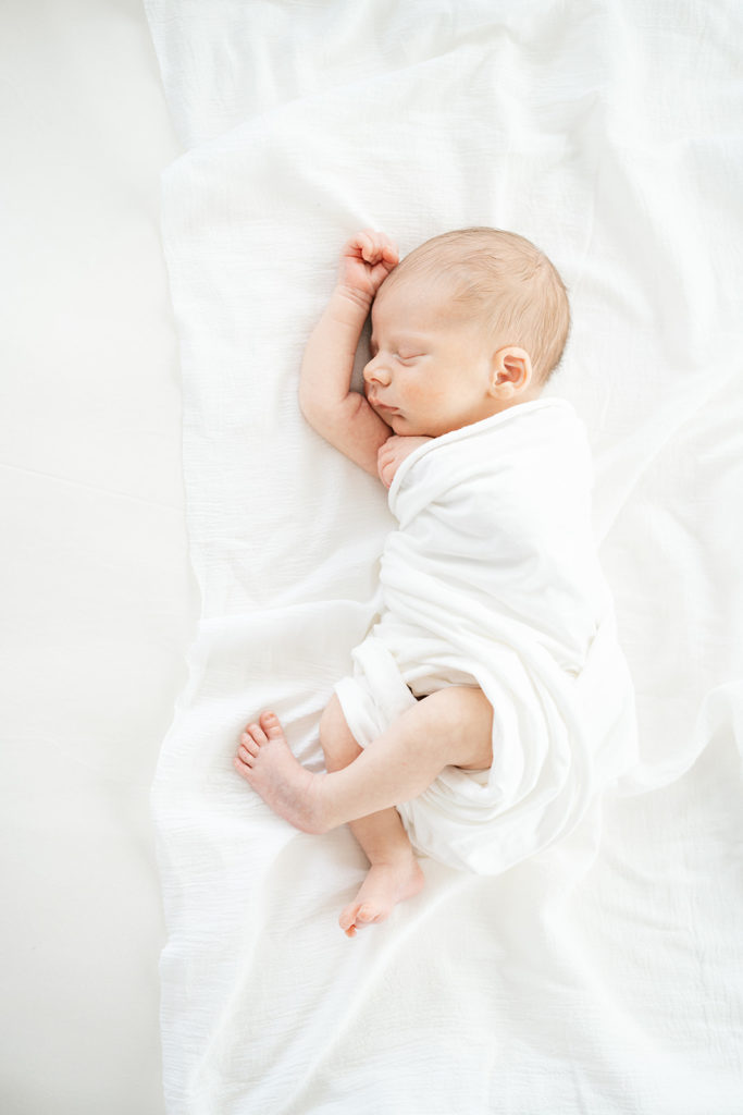 newborn baby in white swaddle asheville